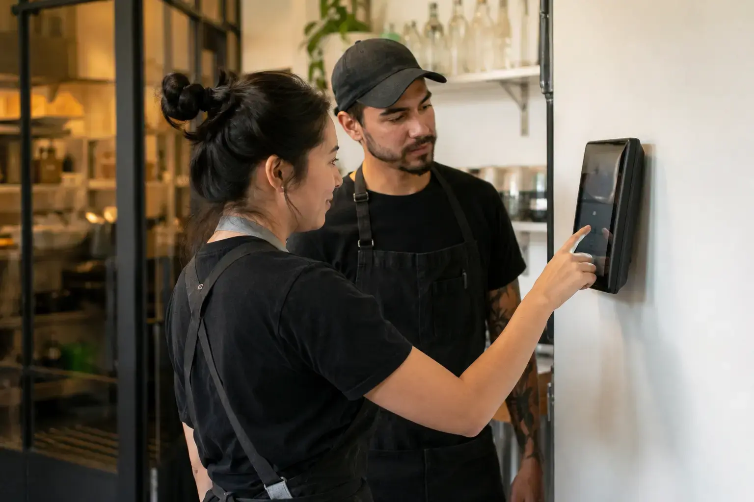 Small business employees using a digital time clock to track work hours